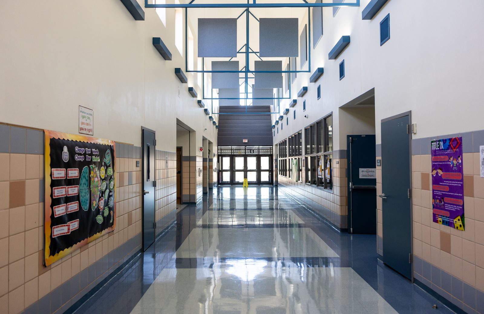 School hallway with the floor polished, bulletin boards up and the doors open, back in use